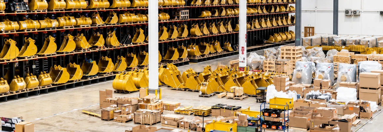 Wheel loader buckets and yard equipment parts stored in a warehouse