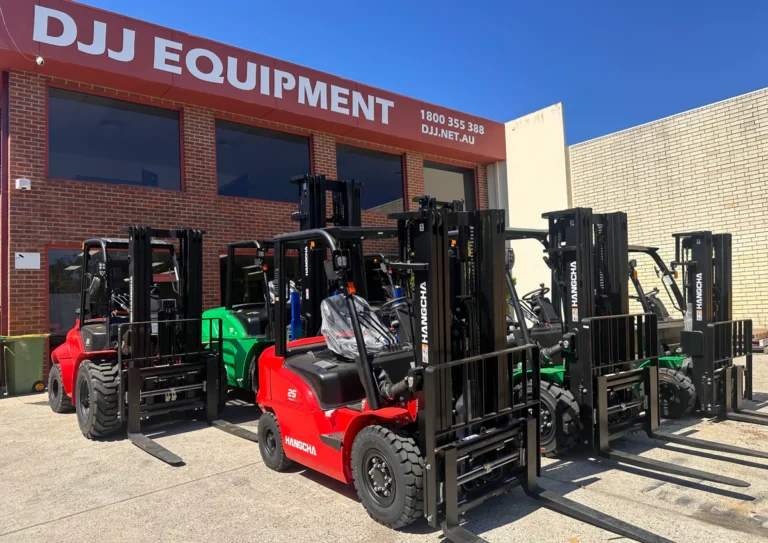 Red and green forklifts lined up outside DJJ Equipment in Bayswater, Perth