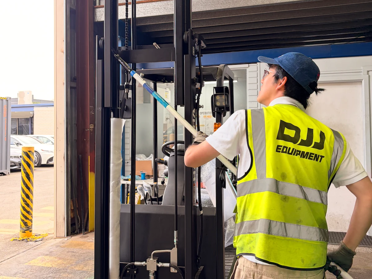 DJJ Equipment technician working on a forklift