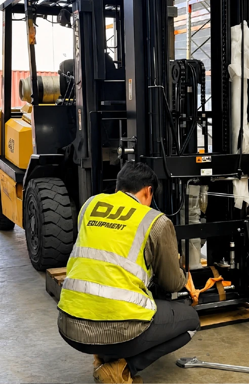 DJJ technician repairing a forklift mast in the workshop