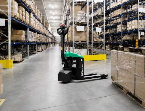 Hangcha XA Series mini pallet truck parked in warehouse aisle beside stacked pallets