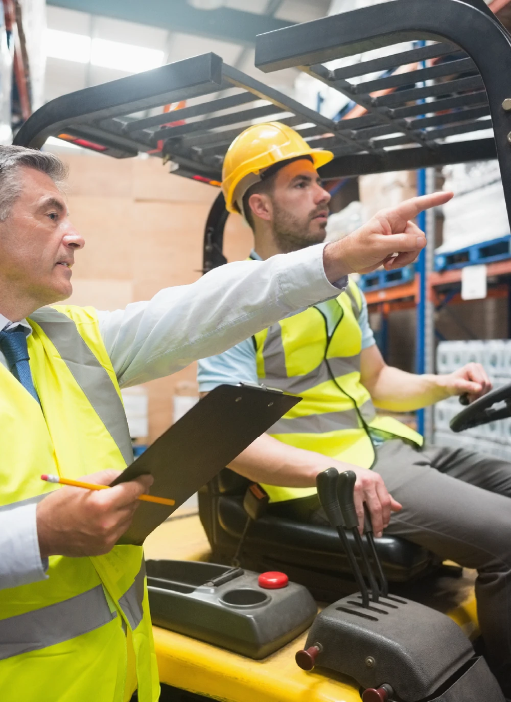Supervisor and operator diagnosing a forklift fault in a warehouse
