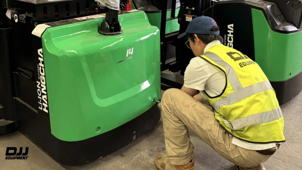 DJJ Equipment technician checking a Hangcha lithium-ion battery unit