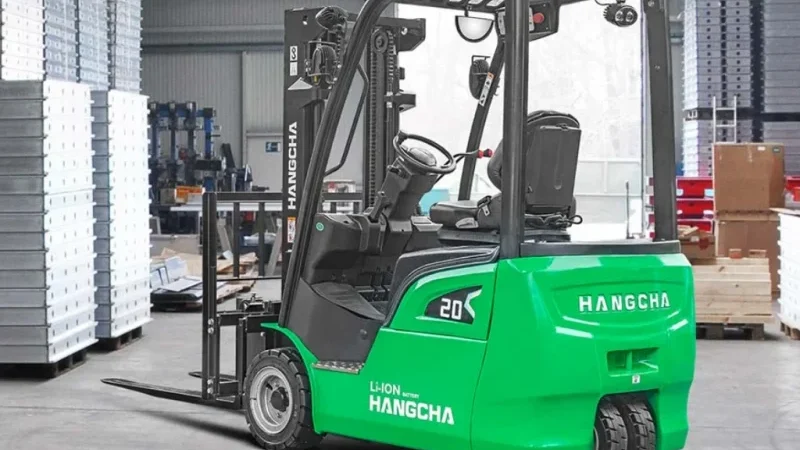 Green Hangcha lithium-ion electric forklift operating in a warehouse aisle