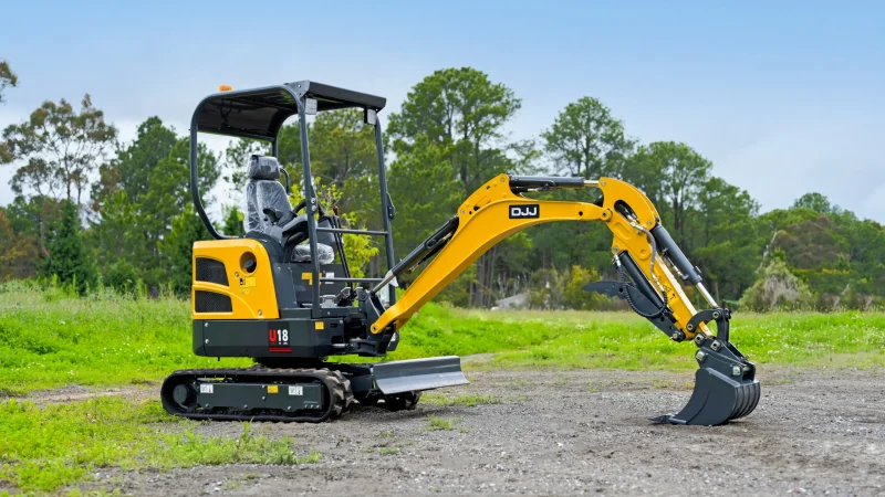 Yuchai U18 mini excavator with its arm extended on a gravel and grass site