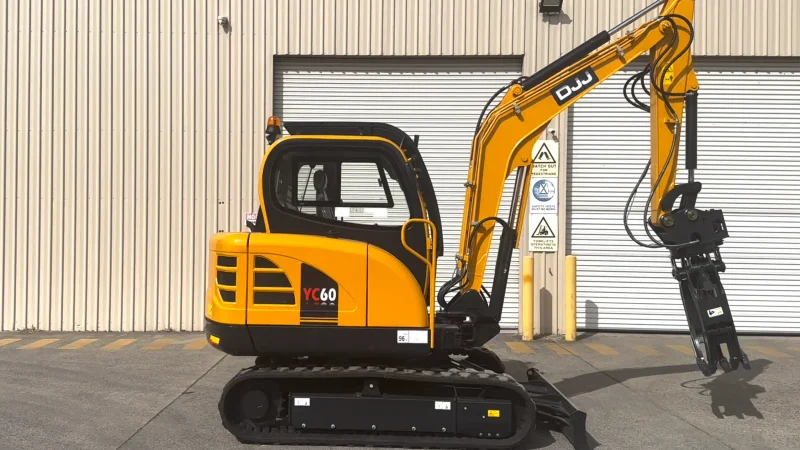 Yuchai YC60 5.7 tonne excavator parked in front of a workshop roller door